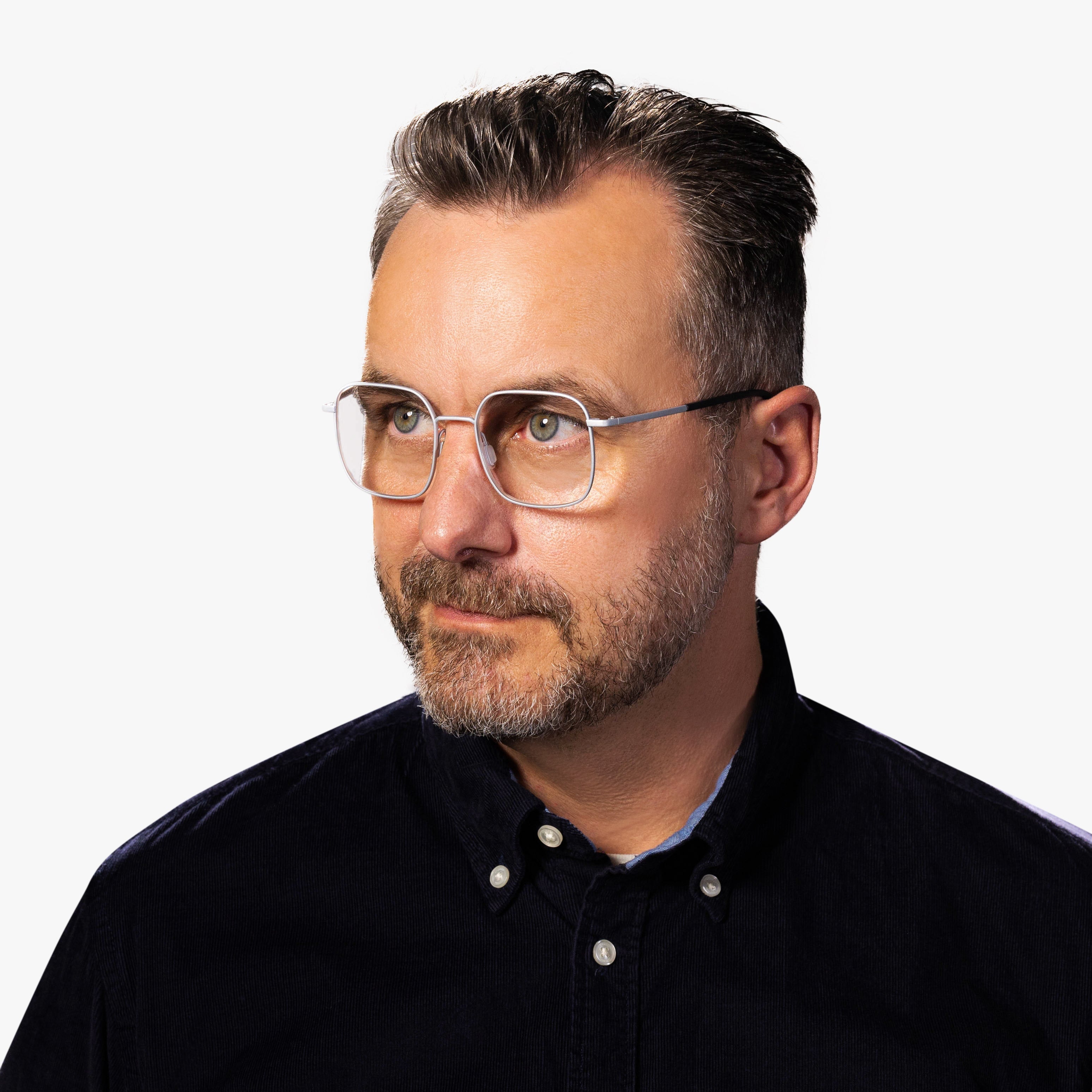 Person wearing Men's Båstad Steel glasses with clear frames