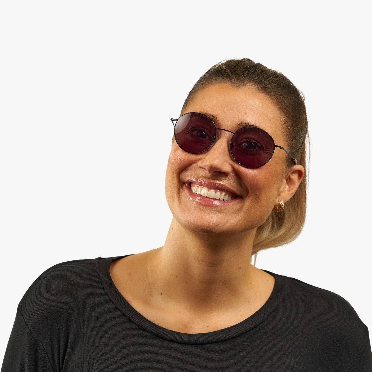 Person wearing Tromsø Black sunglasses with dark round lenses