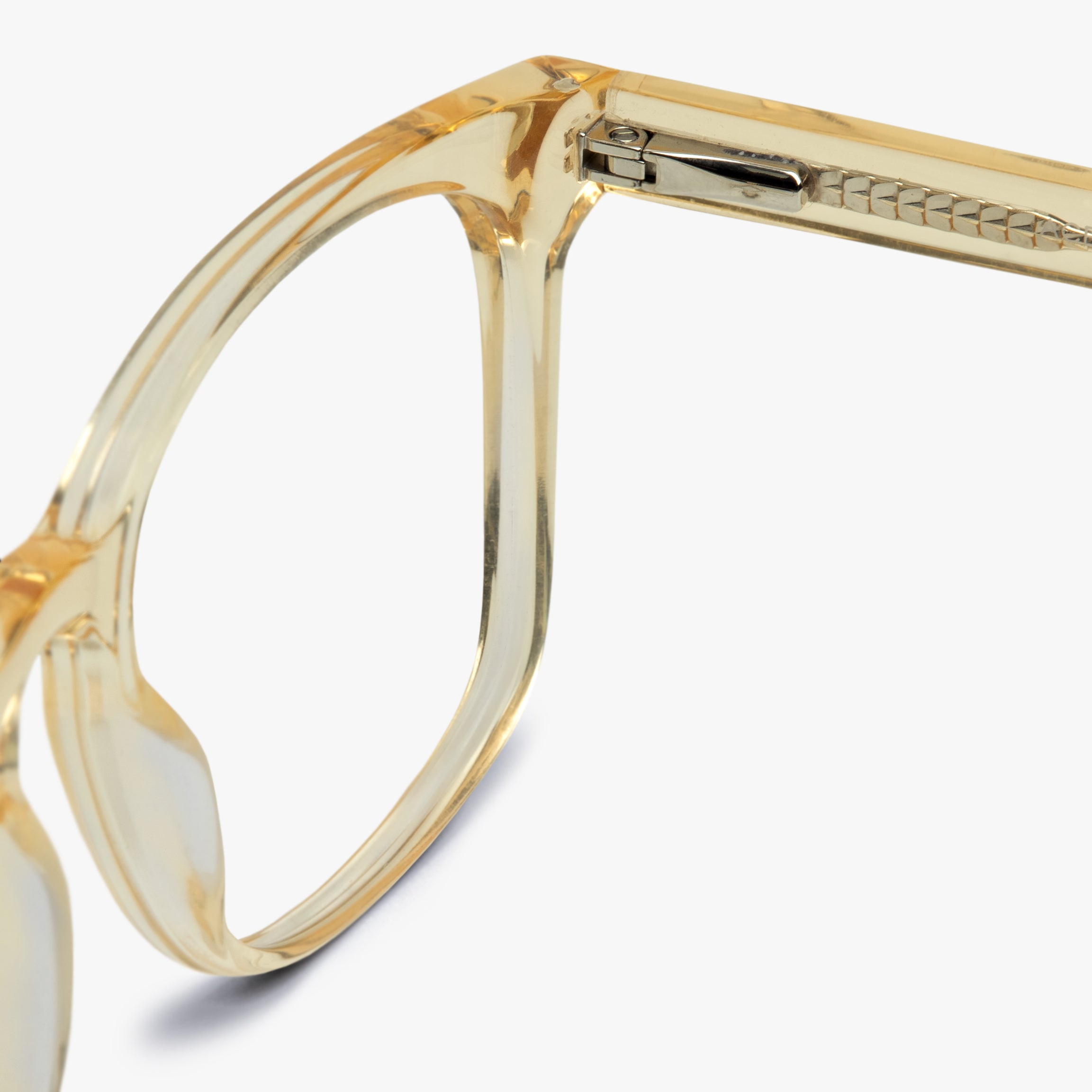 Close-up of crystal lemon eyeglasses frame with gold hinge detail